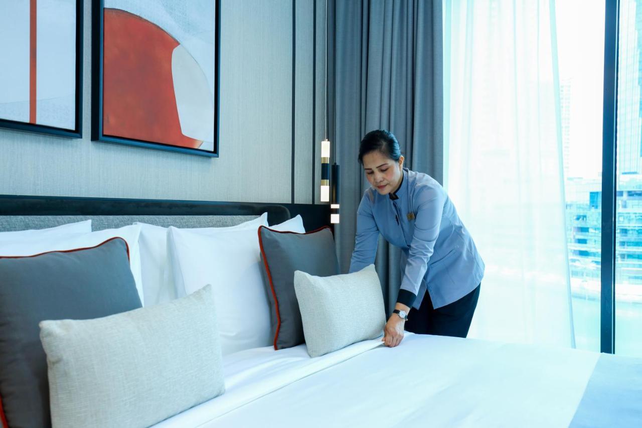 Hotel Charthouse Bahrain Manama Exterior foto A chambermaid making a bed